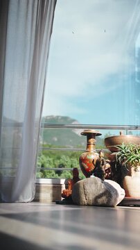 Light curtain gently flowing in the breeze inside a peaceful yoga studio with Buddha statues, creating a calm atmosphere for meditation, mindfulness and holistic wellness.
