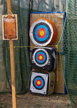 Round archery targets featuring multicolored scoring zones for target practice and competition. Sports equipment, precision, training, recreation and outdoor activities.