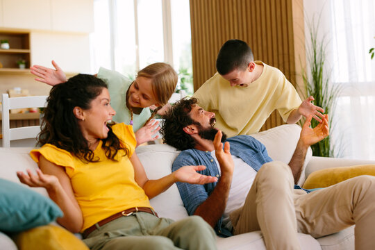 Family enjoying a playful afternoon together in the living room