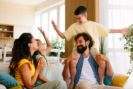 Happy family having fun together on the sofa at home