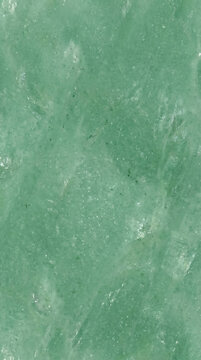 Close-up of polished green stone surface with natural streaks and patterns.