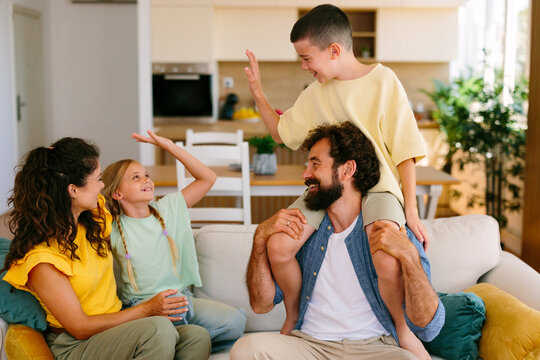 Happy family playing together on the sofa at home
