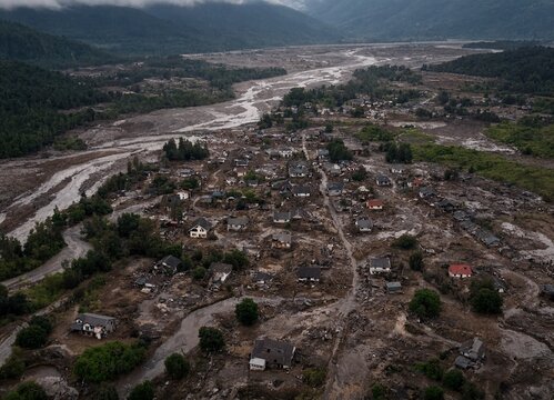 Aerial view of a small mountain village destroyed by a massive mudslide and flash flood disaster