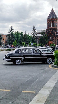 Black GAZ-12 ZIM limousine from the 1950s parked in front of the Church of the Holy Saviour in Gyumri, a vintage Soviet official car, Shirak, Armenia 29.08.2025