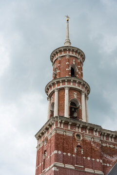 Vladimirskaya church in Balovnevo village Lipetsk region Russia. Historical brick bell tower with ornate architectural details against a cloudy sky in a European city
