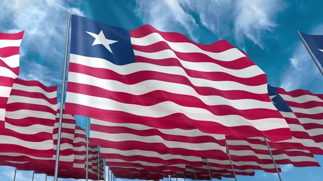 Multiple Liberia flags seamless looping waving on blue sky