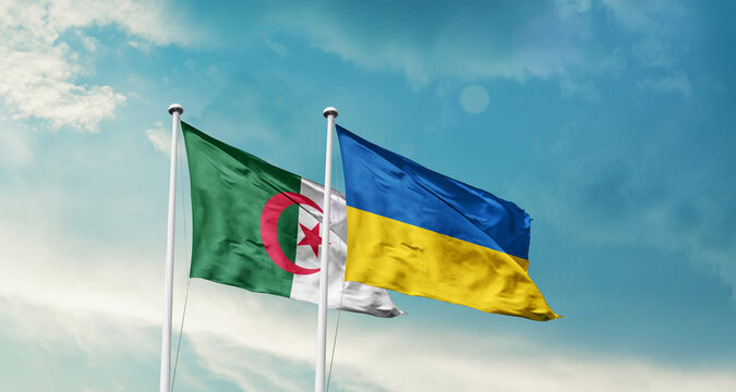 Algeria and Ukraine friendship flags are waving in the sky. Two country flag for agreement or deal. Algeria Ukraine national flag for commitment.