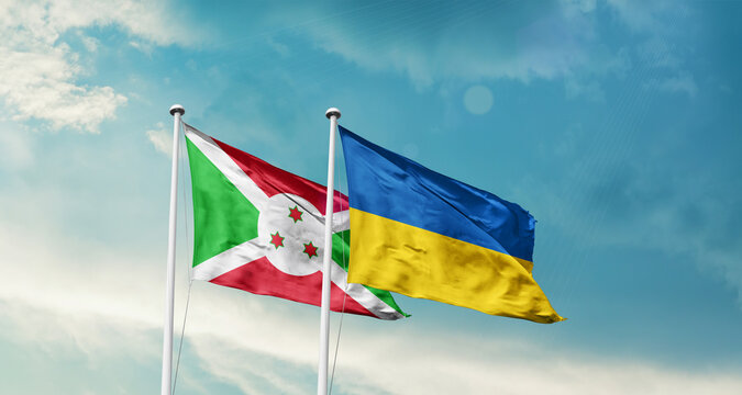Burundi and Ukraine friendship flags are waving in the sky. Two country flag for agreement or deal. Burundi Ukraine national flag for commitment.