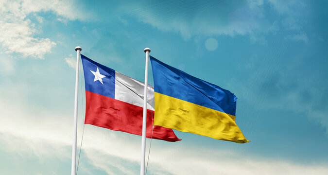 Chile and Ukraine friendship flags are waving in the sky. Two country flag for agreement or deal. Chile Ukraine national flag for commitment.