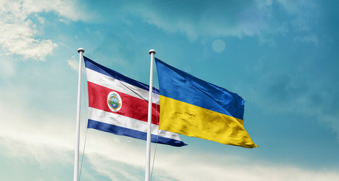 Costa Rica and Ukraine friendship flags are waving in the sky. Two country flag for agreement or deal. Costa Rica Ukraine national flag for commitment.