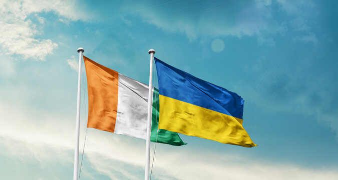 Ivory Coast and Ukraine friendship flags are waving in the sky. Two country flag for agreement or deal. Ivory Coast Ukraine national flag for commitment.