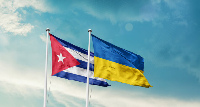 Cuba and Ukraine friendship flags are waving in the sky. Two country flag for agreement or deal. Cuba Ukraine national flag for commitment.