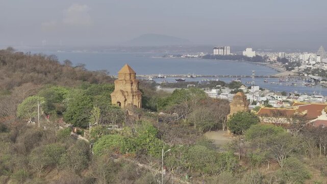 Aerial drone view of Po Sah Inu Cham Towers at sunrise in Phu Thuy, Lam Dong, Vietnam, highlighting ancient Cham architecture and cultural heritage in the morning light.