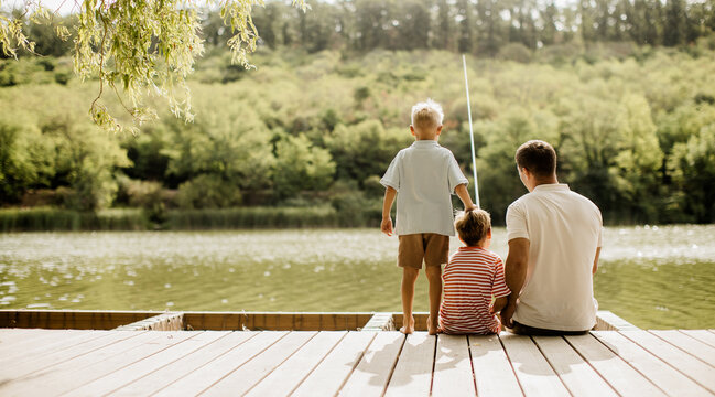 Joyful fishing moments by the peaceful lake in a sunny afternoon