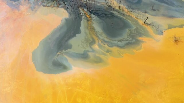  Flying over contaminated mine waters in decanting pond aerial view. Environmental pollution