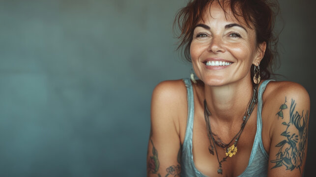 Joyful middle-aged woman with tattoo and friendly smile