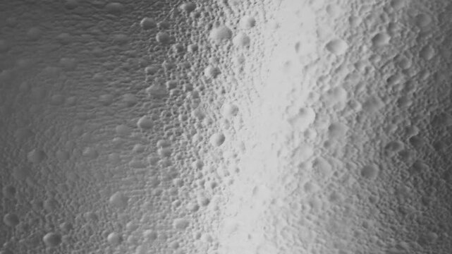 Snowcovered textured surface with rounded frozen bumps in a monochrome closeup