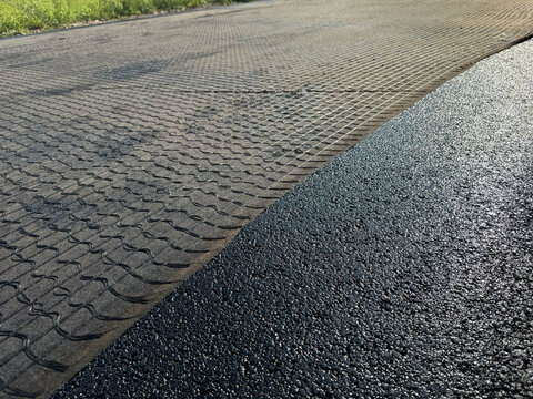 Reinforcing Geogrid Fabric Laid Across a Fresh Asphalt Layer