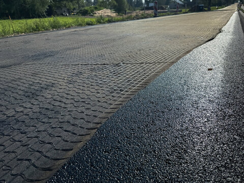 Asphalt Reinforcement Geogrid Extends Across a Road Under Construction