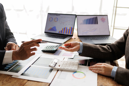 Business professionals analyzing financial data. Discussing market trends and investment strategies during an office meeting