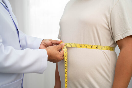 Asian woman with fat belly big size overweight and obesity with measure tape.