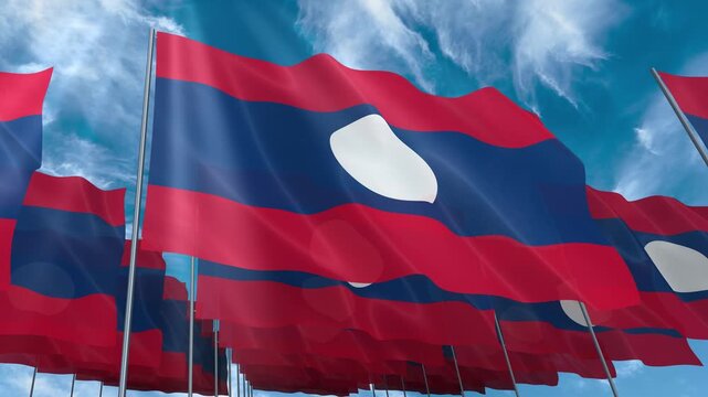 Multiple Laos flags seamless looping waving on blue sky