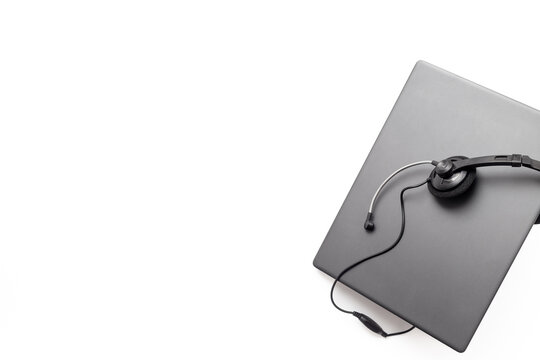 Modern call center desk setup with laptop and headset - online customer service and remote work concept