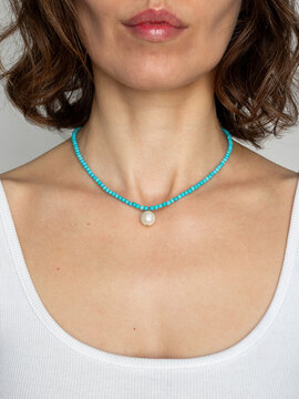 Bohemian gemstone choker on young woman - natural stone turquoise jewelry portrait with artistic beauty and soft daylight