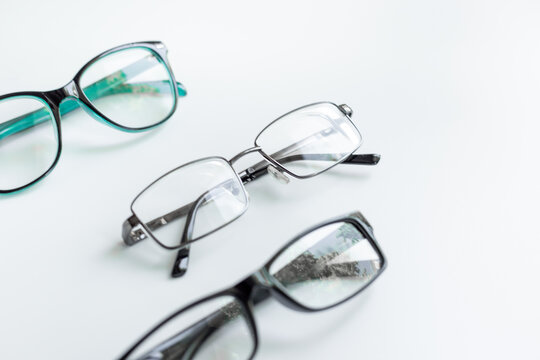 Glasses for vision with different frame and lenses on a white background, top view