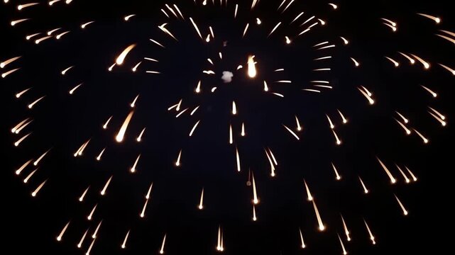 Firework Burst Across Dark Night Sky With Radiant Golden Trails And Festive Sparkling Celebration