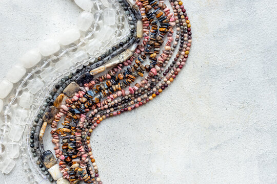 Jewelry and precious concept. Gemstones and beads for necklace, top view, flat lay