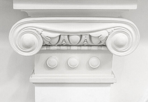 White ionic column capital with classical architectural detail