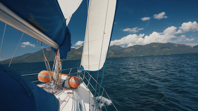Sailing boat moves in the region of the island of Ilha Grande in Brazil