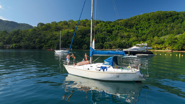 Calm green lagoon with sailing boats on the island of Ilha Grande, Brazil