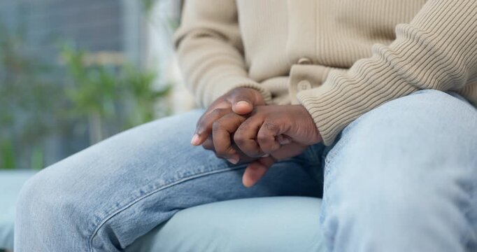 Stress, hands and man in home with anxiety, mental health or overthinking for fear or phobia. Upset, worry and person on sofa stimming in living room for trauma, bad news or emotions in apartment.