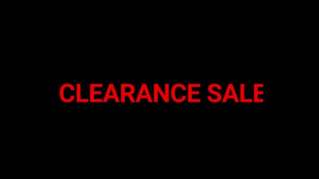 Clearance sale text in red neon font glows against a dark background to promote retail discounts and seasonal shopping events.