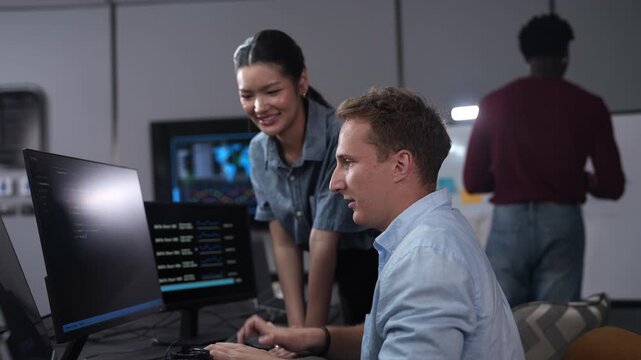 Software developer team programming and coding on computer screen in modern IT office, Diverse male and female collaboration, technology business startup, teamwork and future digital innovations