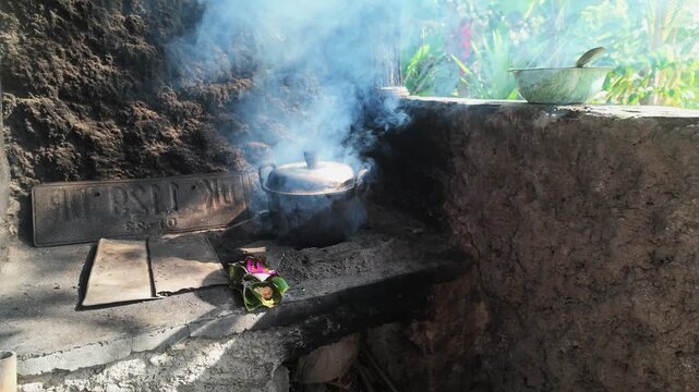 Cooking Pot Steaming over Traditional Wood Fire Stove in Balinese Kitchen