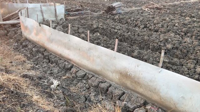 Tarpaulin barrier system on local traditional farm