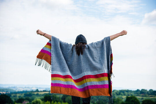 Freedom under colorful striped poncho.