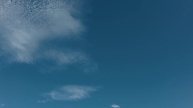 Blue sky with thin, high-altitude clouds drifting across the sky
