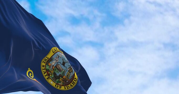 Close-up of the Idaho state flag waving in the wind on a clear day
