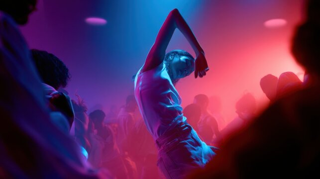 Young woman dancing expressively under vibrant blue and pink lights surrounded by a crowd enjoying a lively party atmosphere