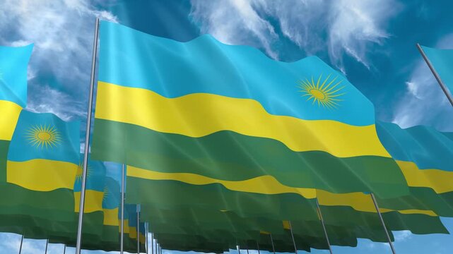 Multiple Rwanda flags seamless looping waving on blue sky