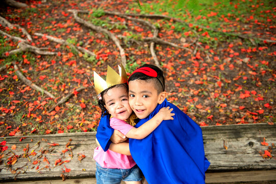 Joyful siblings in autumn park
