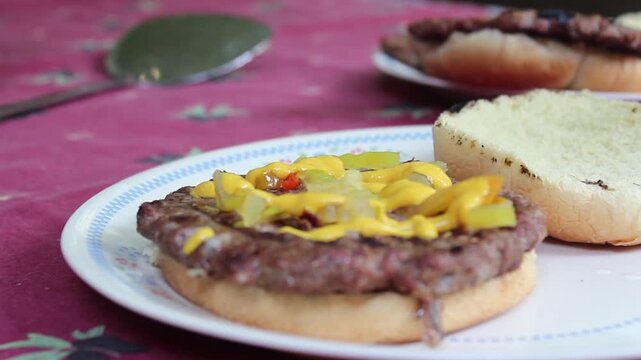 Applying Mustard To A Burger