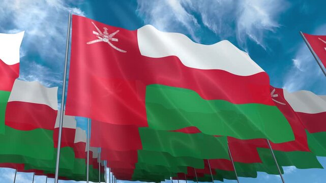 Multiple Oman flags seamless looping waving on blue sky
