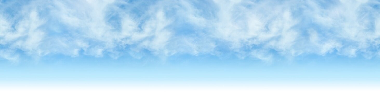 Sky - Bright blue cloudy skyline background. Repeating clouds to make an image of infinite width.