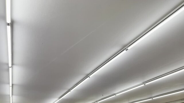 High contrast linear fluorescent light bars in modern industrial interior