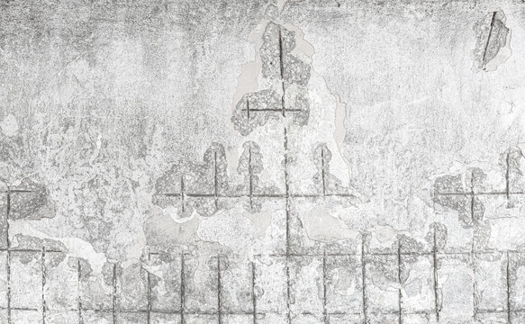 Damaged concrete wall showing exposed rebar structure